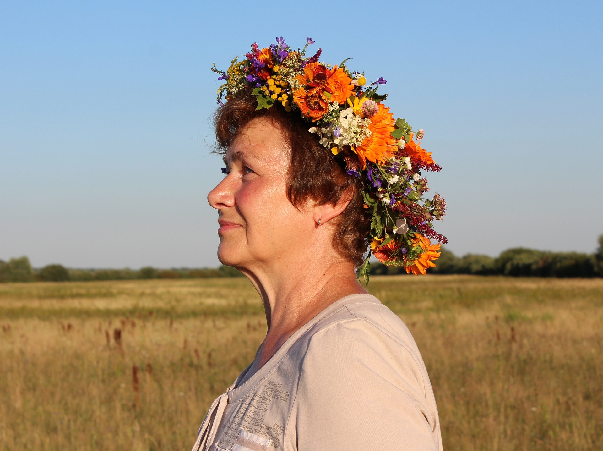 profile of a mature woman wearing a crown of flowers