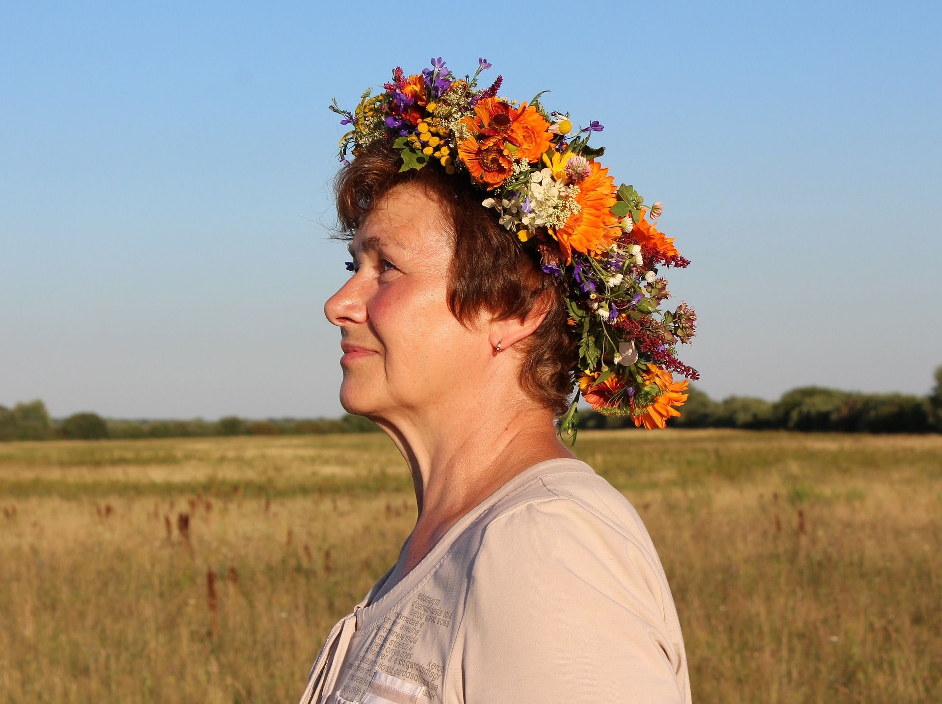profile of a mature woman wearing a crown of flowers